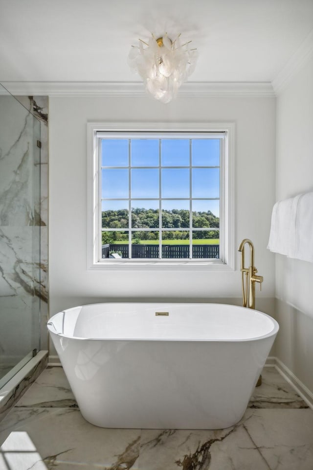 bathroom with marble finish floor, a marble finish shower, crown molding, and a soaking tub