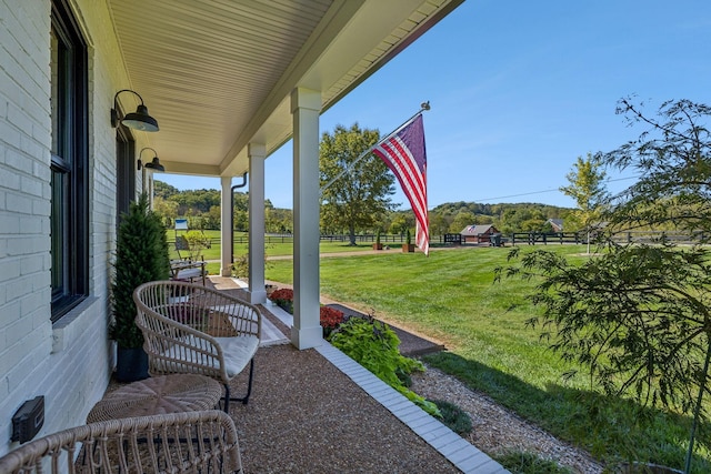 view of patio with a porch and fence