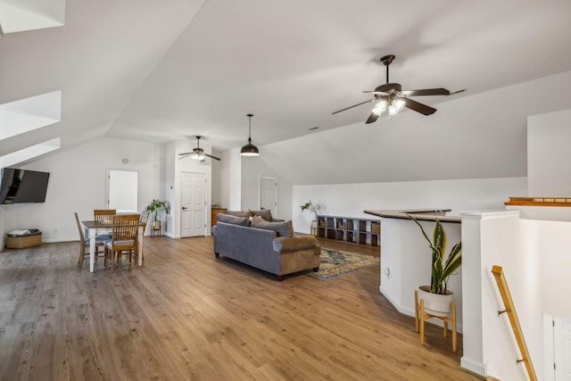 living area with lofted ceiling and wood finished floors