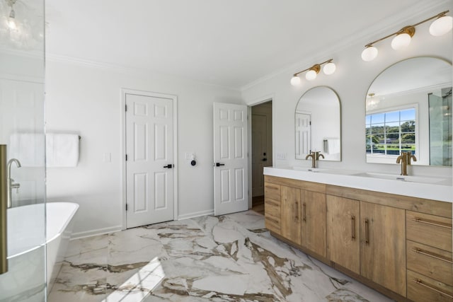 full bath with ornamental molding, a soaking tub, a sink, and marble finish floor