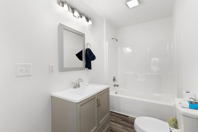 bathroom with visible vents, toilet, shower / tub combination, wood finished floors, and vanity