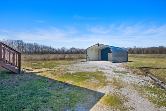 view of yard with driveway and a detached carport