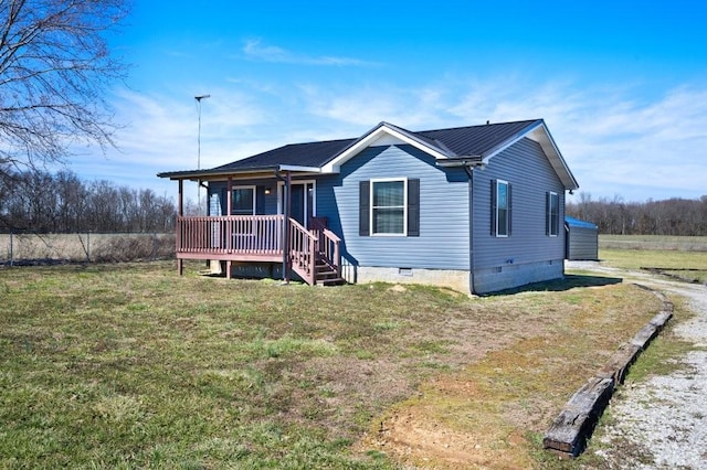 view of front of house featuring a porch, a front yard, crawl space, and metal roof