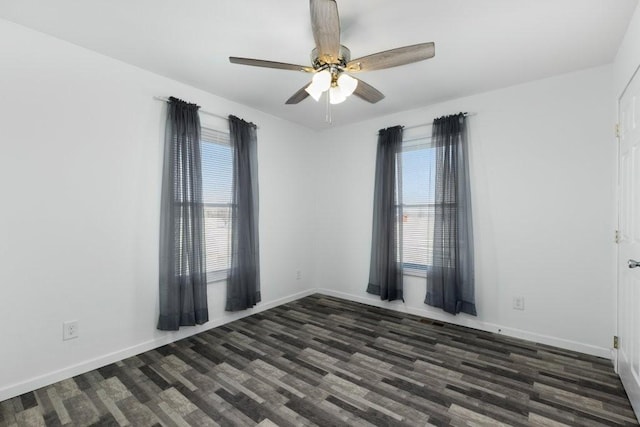 unfurnished room with ceiling fan, baseboards, and dark wood finished floors