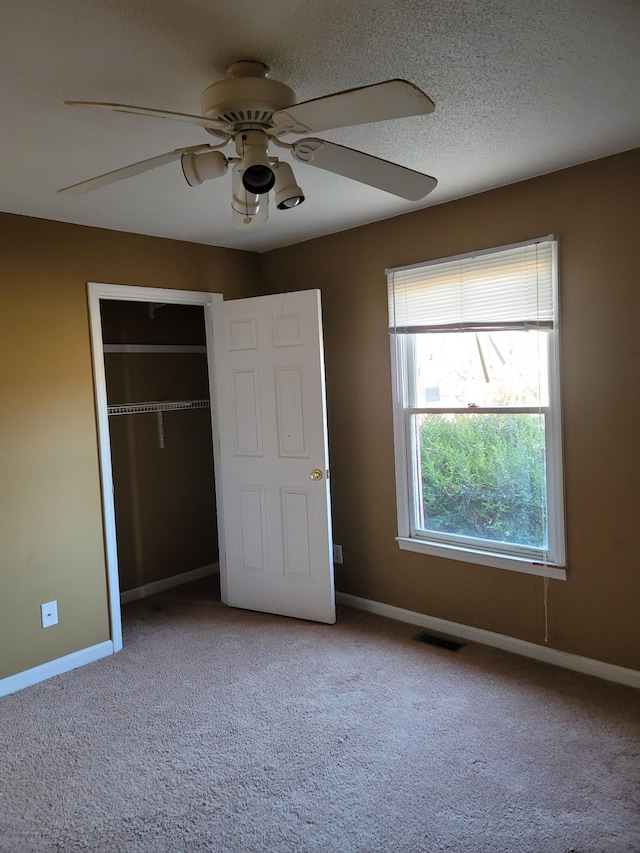 unfurnished bedroom with carpet, visible vents, and baseboards