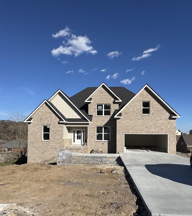 view of front of home featuring board and batten siding, concrete driveway, and an attached garage