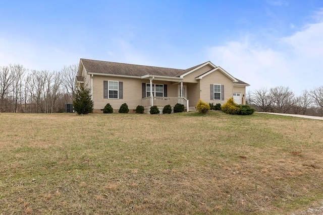 ranch-style house with an attached garage, a porch, and a front yard