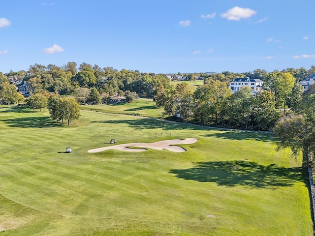 view of home's community featuring a yard and golf course view