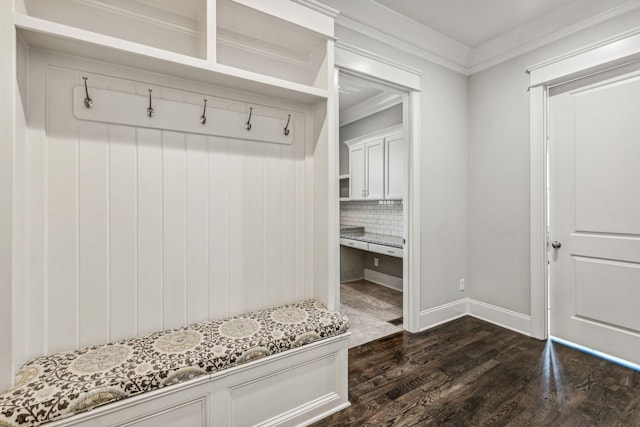 mudroom with baseboards, ornamental molding, and dark wood finished floors