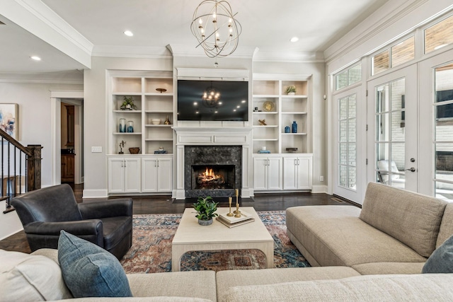 living area featuring baseboards, ornamental molding, dark wood-style flooring, and a high end fireplace