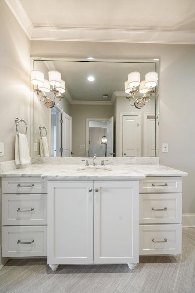 bathroom with visible vents, a chandelier, crown molding, and vanity