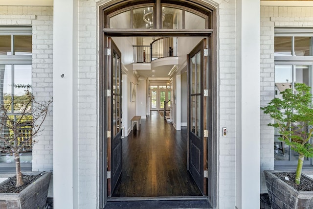 property entrance featuring brick siding