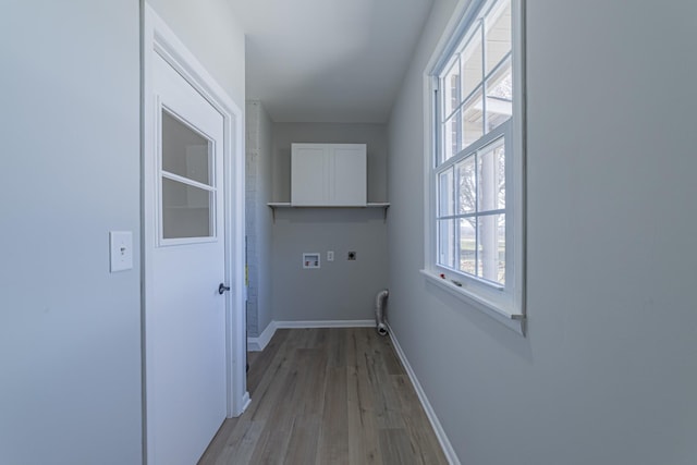 laundry area with washer hookup, cabinet space, light wood-style flooring, electric dryer hookup, and baseboards