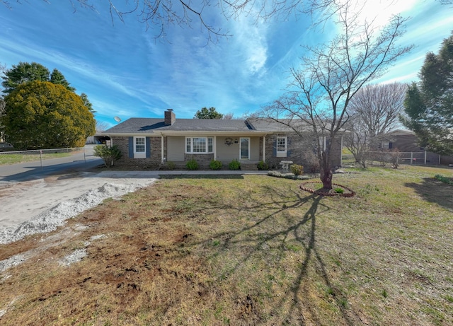 ranch-style home with a front lawn, a chimney, and fence