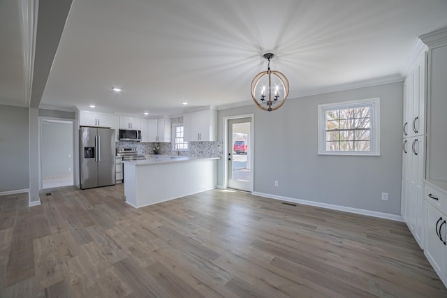 kitchen with stainless steel appliances, wood finished floors, baseboards, ornamental molding, and tasteful backsplash