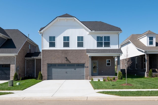 view of front facade with a garage, driveway, a front lawn, and brick siding