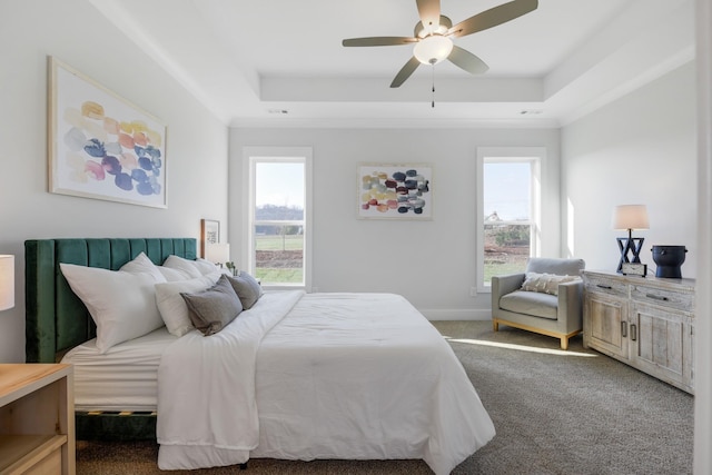 bedroom featuring carpet, a raised ceiling, a ceiling fan, and baseboards