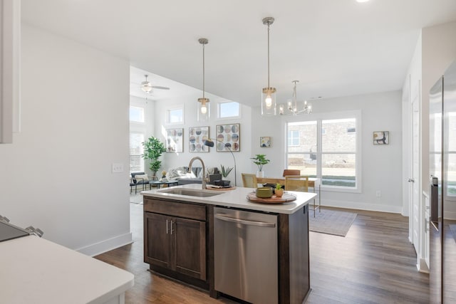 kitchen with plenty of natural light, a center island with sink, light countertops, and stainless steel dishwasher