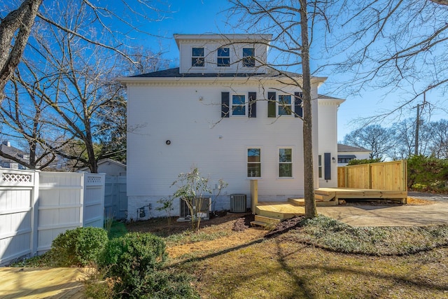 rear view of house with crawl space, central AC, fence, and a wooden deck