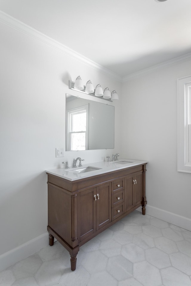 bathroom with double vanity, baseboards, ornamental molding, and a sink