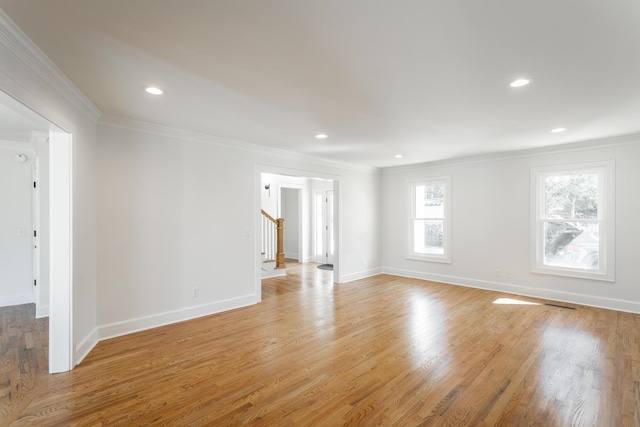 unfurnished room featuring recessed lighting, baseboards, stairs, ornamental molding, and light wood finished floors