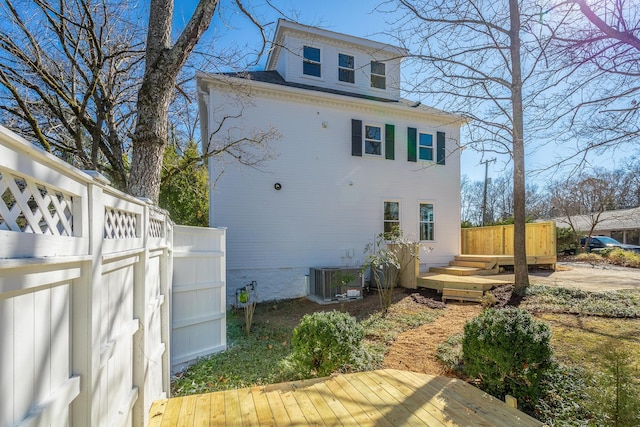 back of property featuring a deck and central air condition unit