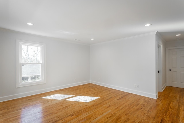 spare room with light wood-type flooring, crown molding, baseboards, and recessed lighting