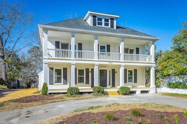 view of front of property with a porch and roof with shingles