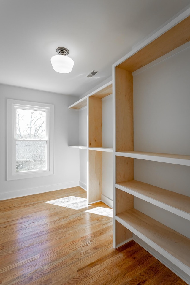 spacious closet with wood finished floors and visible vents