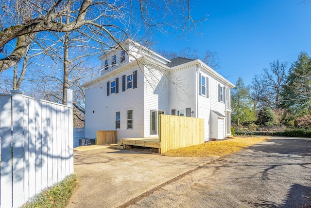 view of side of property with driveway and an attached garage