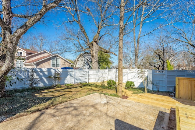 view of yard with a patio area, a fenced backyard, and a deck