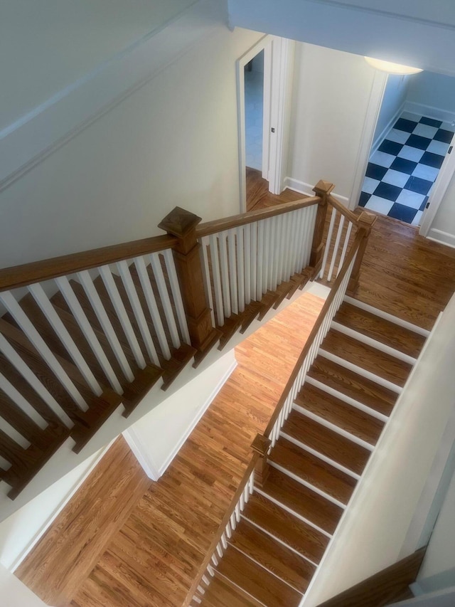 staircase with wood finished floors