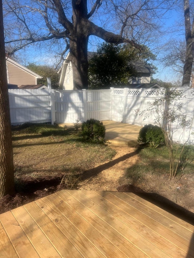 view of yard featuring a deck and fence