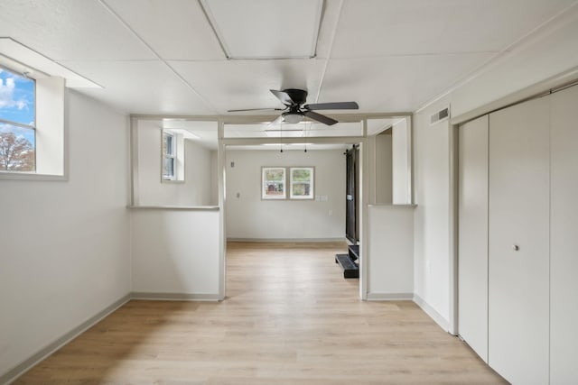 interior space featuring light wood-style flooring, visible vents, and baseboards