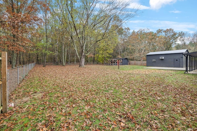 view of yard featuring a fenced backyard, a shed, and an outdoor structure