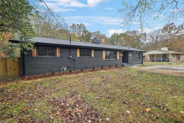 view of front of property featuring brick siding, a chimney, crawl space, fence, and a front lawn