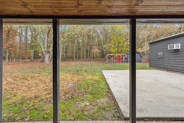 view of yard with a patio area, a storage unit, and an outbuilding