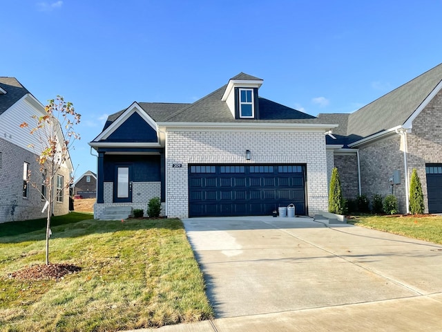 view of front of home featuring driveway, brick siding, a front lawn, and an attached garage