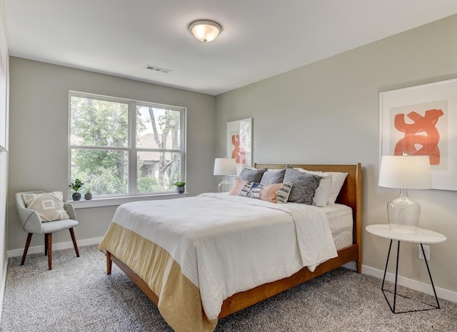 carpeted bedroom with baseboards and visible vents