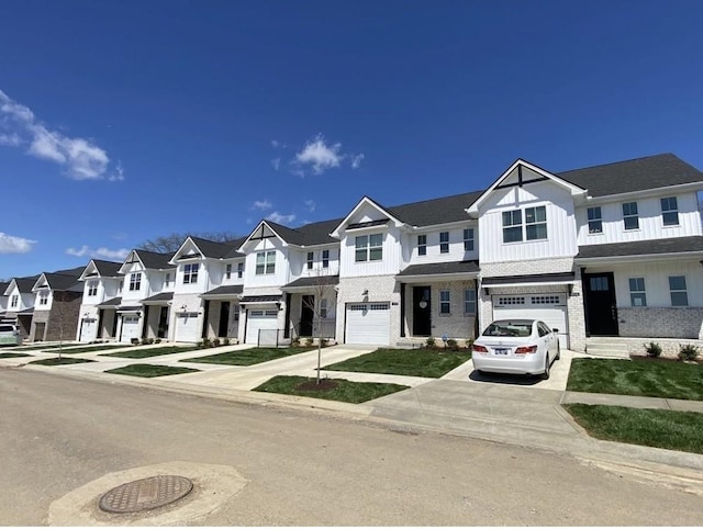 view of property featuring board and batten siding, a residential view, driveway, and an attached garage