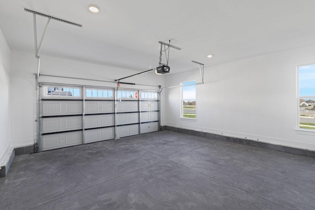 garage featuring baseboards, recessed lighting, and a garage door opener