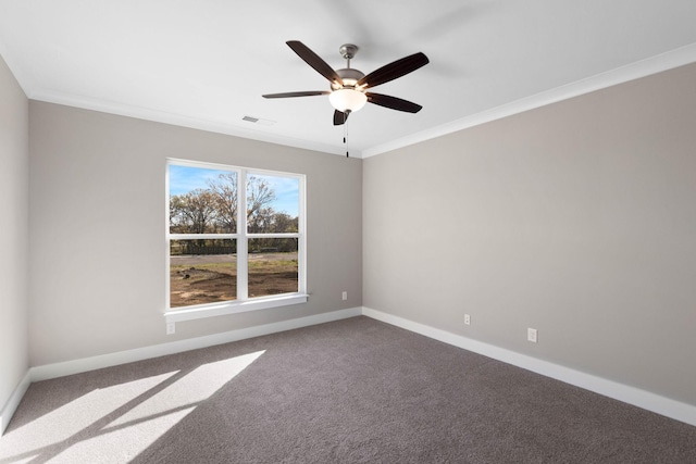 spare room featuring baseboards, visible vents, a ceiling fan, ornamental molding, and carpet