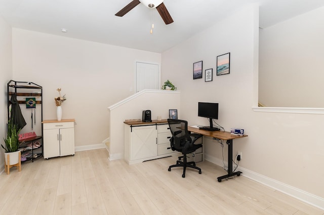 office featuring baseboards, a ceiling fan, and light wood-style floors