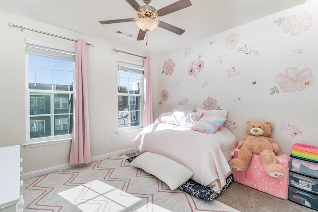 bedroom featuring a ceiling fan, light colored carpet, visible vents, and baseboards