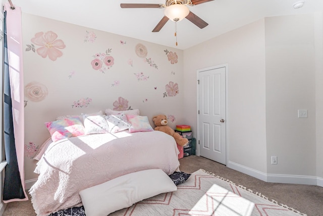 bedroom featuring light carpet, ceiling fan, and baseboards