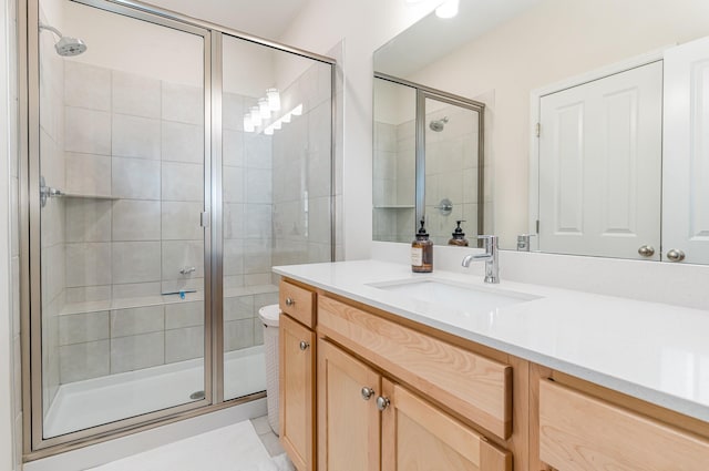 bathroom featuring a shower stall and vanity