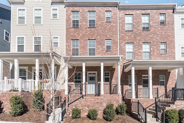 townhome / multi-family property with brick siding