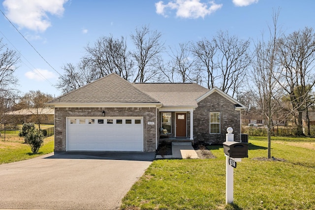 single story home with aphalt driveway, roof with shingles, an attached garage, a front lawn, and brick siding