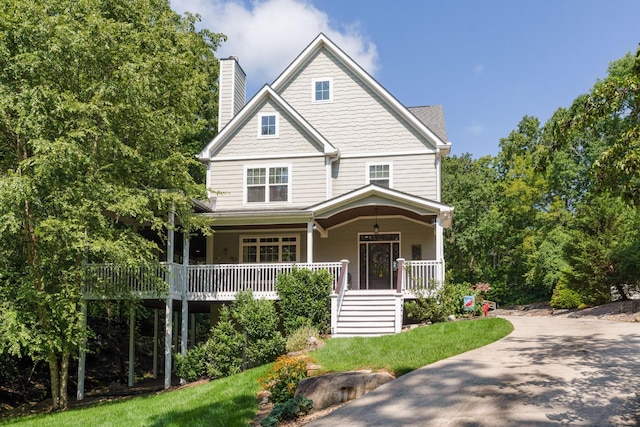 view of front of house with a chimney and a porch