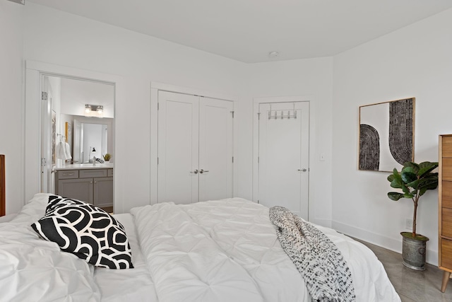 bedroom with ensuite bathroom and baseboards